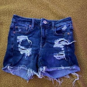 Ripped, dark blue American Eagle jean shorts. Size 4.